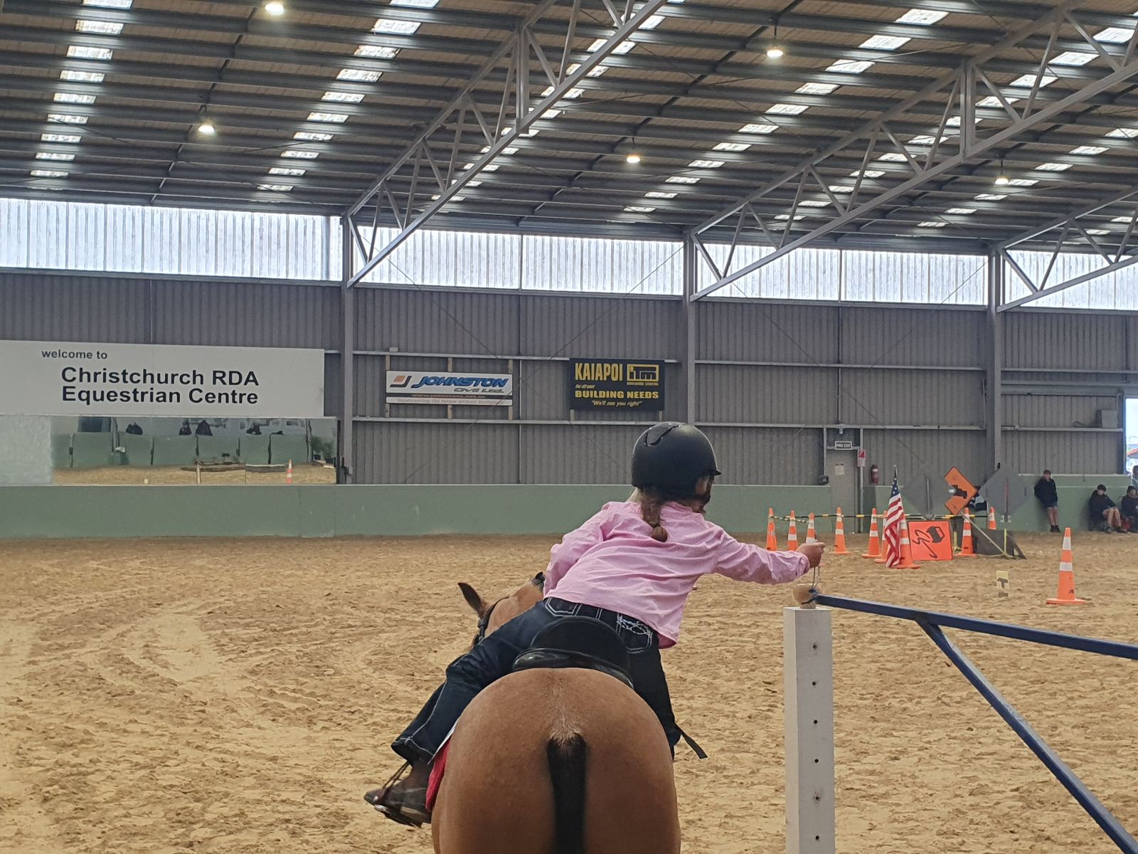 A rider jumping a small fence during an equitation clinic